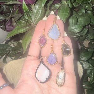 Gold and Purple Gemstone Pendants in show